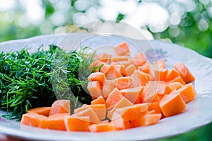 Carrots and dill. Healthy food. Vegetables. Orange and green. Vegetables for proper nutrition. Vegetables on the plates. Diced car