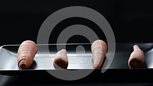 Carrots gyrating with black background. Daucus carota