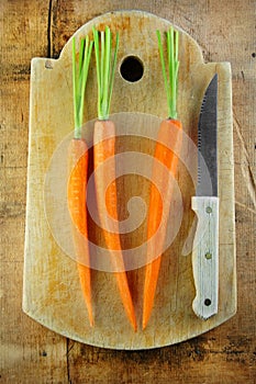 Carrots and Knife on Cutting Board