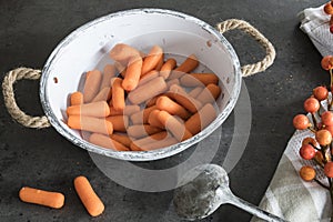 Carrots in white vintage colander