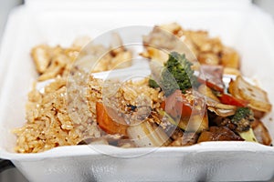Carry Out Container Filled with Stirfried and Grilled Foods