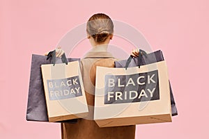 Carrying black Friday paperbags