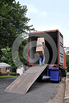 Carrying boxes into moving truck