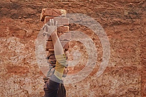 While carrying the bricks