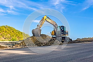 Carrying out road construction works using an excavator