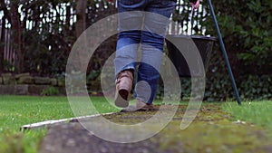 Carrying plastic bucket down garden path