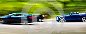 Cars in blurred motion on road. Abstract background.