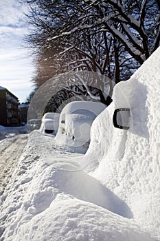 Cars buried in snow