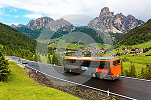 Cars & buses traveling on a scenic highway thru a green grassy valley