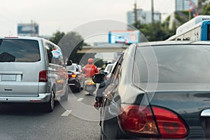 Cars on busy road in the city with traffic jam photo