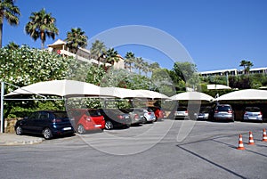 Cars in a car park. Vehicles in a car port. Parking lot. Parking area. Car park.