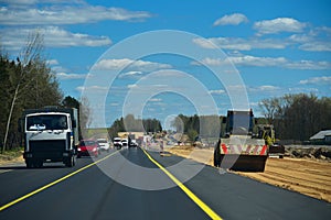 Cars circle the road under construction.