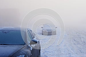 Cars covered with snow and hoar-frost standing on the roadside. all white,