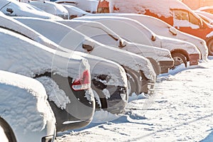 Cars covered in snow on a parking lot in the residential area