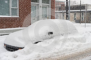 Cars covered in snow during snowstorm