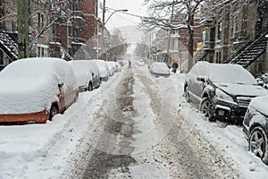 Cars covered in snow during snowstorm