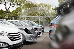 Cars Damaged In Motor Vehicle Accidents Parked In Garage Repair Shop photo
