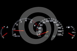 A cars dashboard panels lit up at night with European speedometer