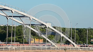 Cars drive across the bridge.