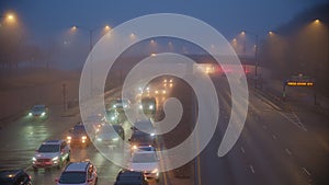 Cars drive along a foggy road with poor visibility in fog. Chicago