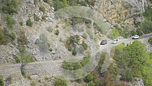 Cars drive along the mountain winding road