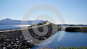 Cars drive to Storseisundet bridge in Atlantic road Norway at sunny day