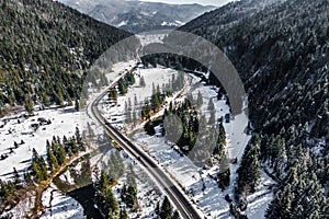 cars drives on a mountain winter road.