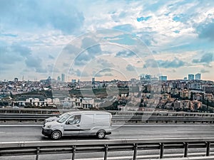 Cars driving along the highway against the backdrop of the suburbs