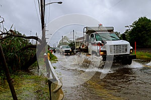 Cars driving on a flooded road during a flood heavy rain