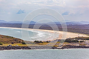 Cars driving on Gallows Beach at Coffs Harbour.