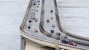 Cars driving on snowy road in winter, traffic driving on the bridge, highway