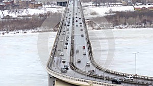 Cars driving on snowy road in winter, traffic driving on the bridge, highway
