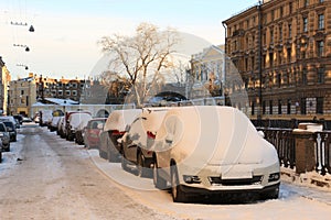 Cars on the embankment, noticeable by snow