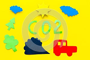 Cars emitting carbon dioxide. Pollution concept. harm the environment. Car and smoke cutout on yellow background top