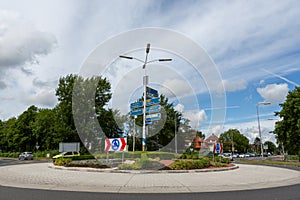 Cars entering a roundabout with traffic direction signs on the van Pallandtlaan in the village of Sassenheim