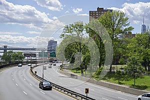 Cars on FDR Drive along East River with a view on lower Manhattan