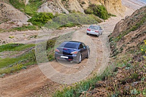 Cars goes down the mountain dirt road