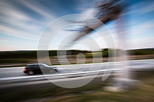 Cars going fast on a highway