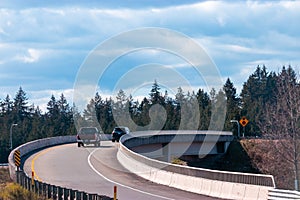 cars going up over an interchange on a freeway in summer