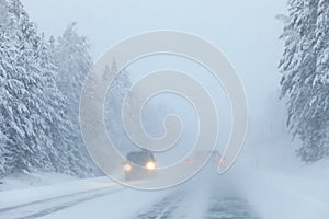 Cars in heavy snowstorm with weak visibility