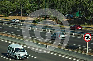 Cars on highway with heavy traffic and SPEED LIMIT sign in Madrid photo