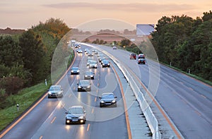 Cars on highway road at sunset