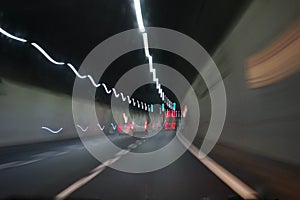 Cars inside a highway tunnel. Color light trails effect.