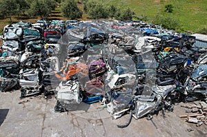 Cars in junkyard, pressed and packed for recycling