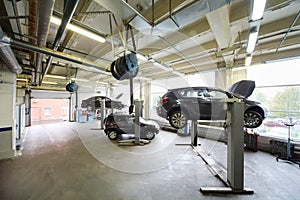 Cars on lifts in small service station