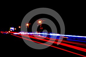 Cars light trails on a curved highway at night. Night traffic trails. Motion blur. Night city road with traffic headlight motion.