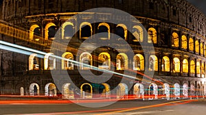 Cars light trails near the Coloseum, Rome, Italy. Also Known As Flavian Amphitheatre In Evening Or Night Time. Famous World