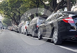 cars parked row in city street, car park photo