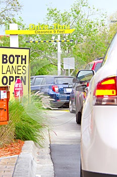 Cars in a long line at a drive thru restaurant