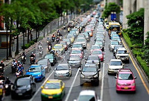 Cars and motorcycles in busy road with tilt shift effect